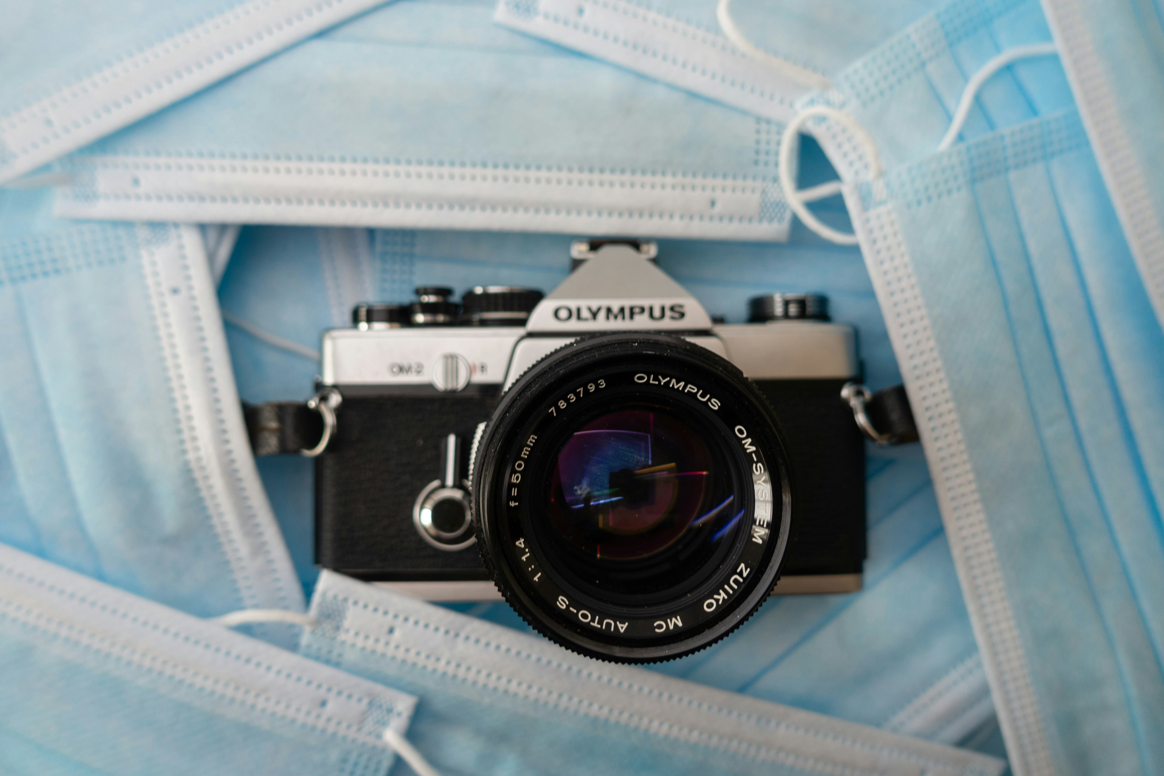 black and silver canon dslr camera on white paper